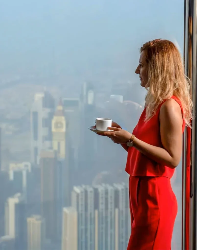 a girl drinking coffee at the lounge level 152 at Burj khalifa